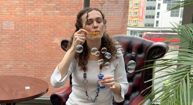 A patient blowing bubbles at the Active Breathing Course for people with Long Covid