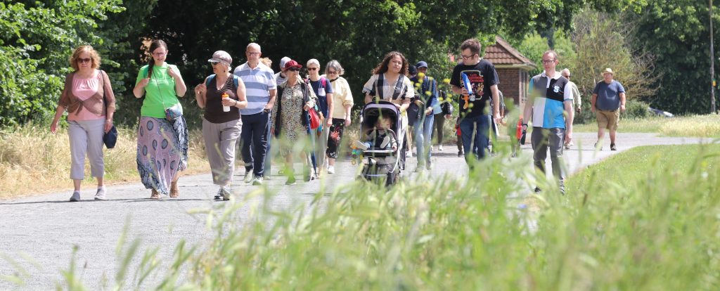 A group of people walking in Wimbledon Park