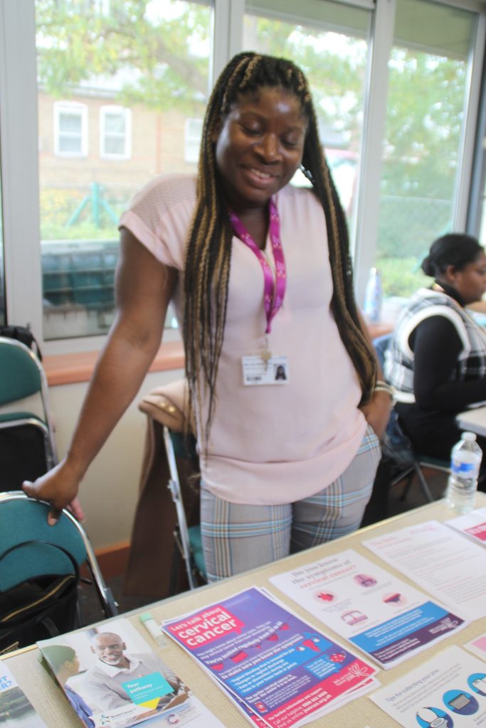 Lady standing in front of table with leaflets