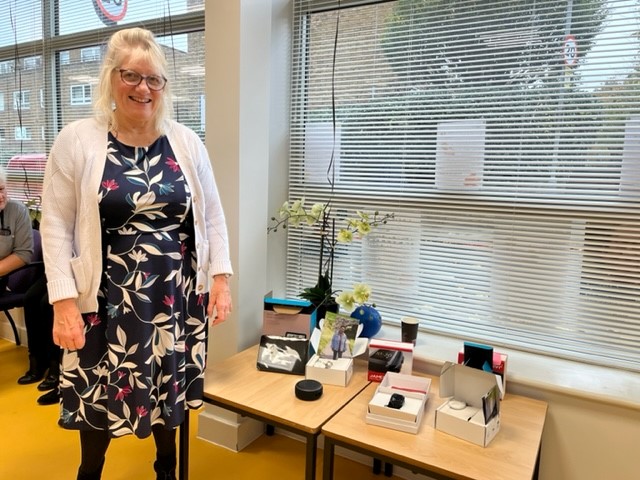 Wendy Jones from the Wandsworth Council Sensory Impairment Team with a table of technology aids for people living with sight loss