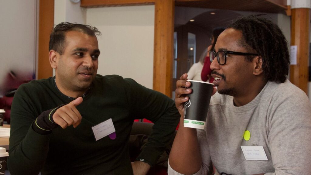 Two men chatting at south west London voluntary sector mental health event