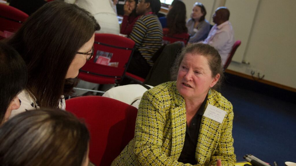 Odette Battarel of Kingston Association for the Blind talks to another delegate at south west London voluntary sector mental health event
