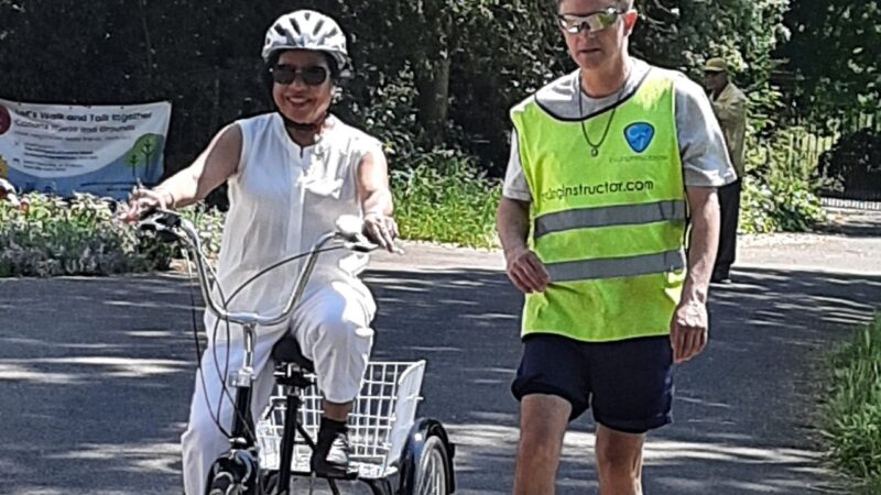 Merton Ethnic Minority Centre cycling class participant with cyclist