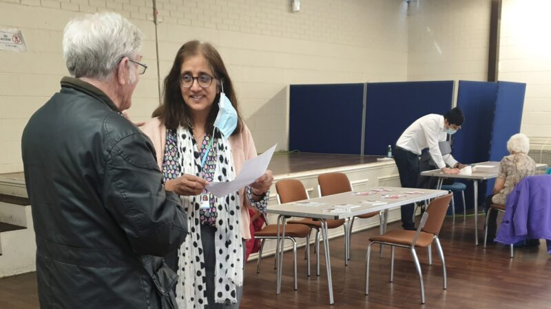 Two people talking at an events venue in Sutton