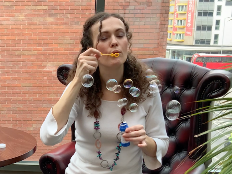 A patient blowing bubbles at the Active Breathing Course for people with Long Covid