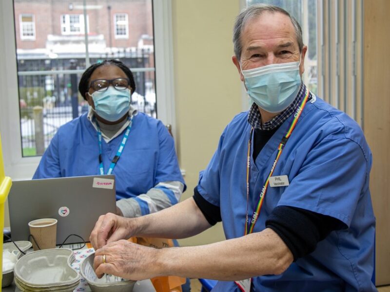 Two volunteers working at a vaccination centre in Sutton