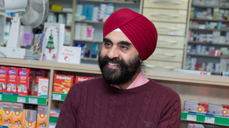 A pharmacist serving a customer