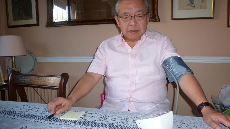 A Wandsworth patient checks his blood pressure at his kitchen table in his home