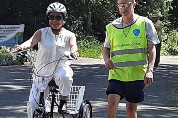 Merton Ethnic Minority Centre cycling class participant with cyclist