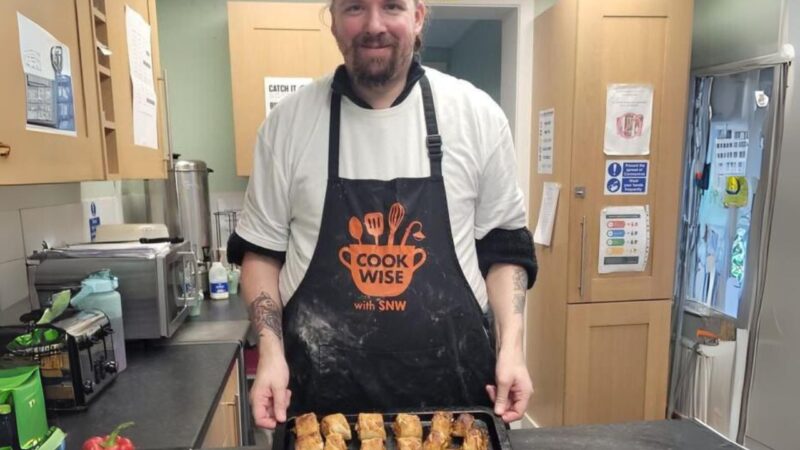 Man learning cooking skills at Sutton Night Watch