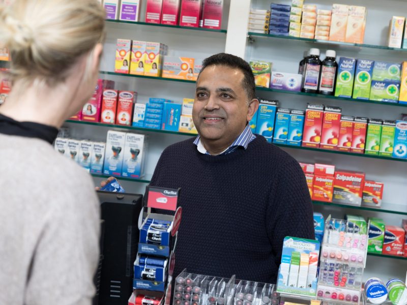 A Kingston pharmacist helps a customer