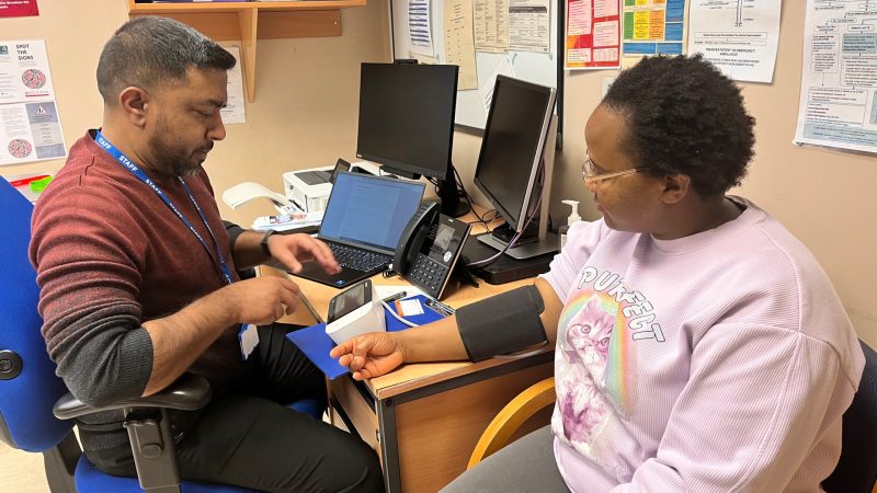 Woman having her blood pressure checked at pop-up