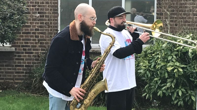 Saxaphone and trombone players at launch of wlison wellbeing hub